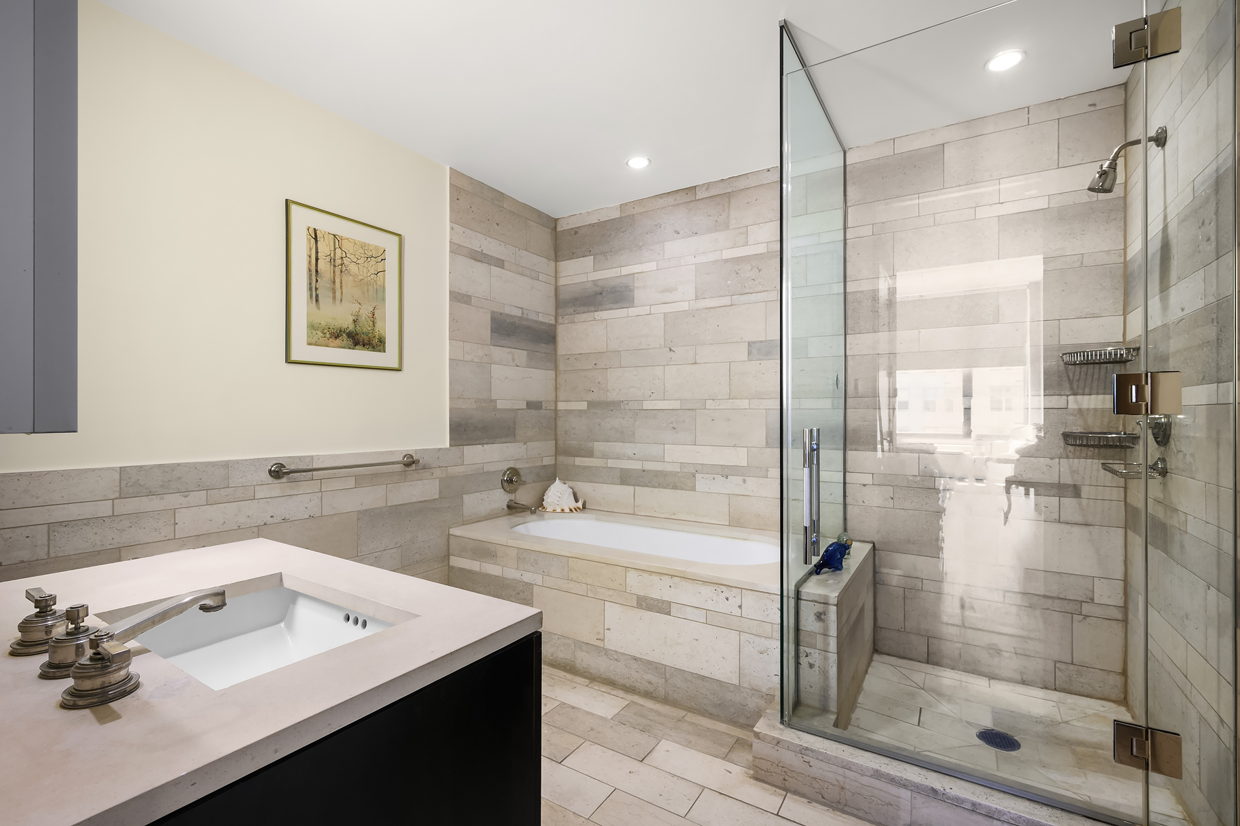 450 East 83rd Street, Unit 4H Manhattan, NY 10028 - Photo 5 of 16 a bathroom with a shower sink and mirror