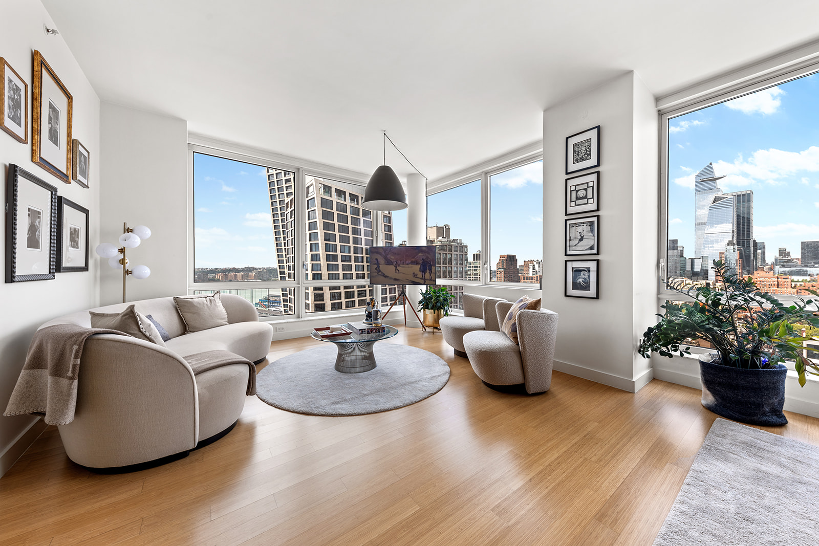 a living room with fireplace furniture and a potted plant