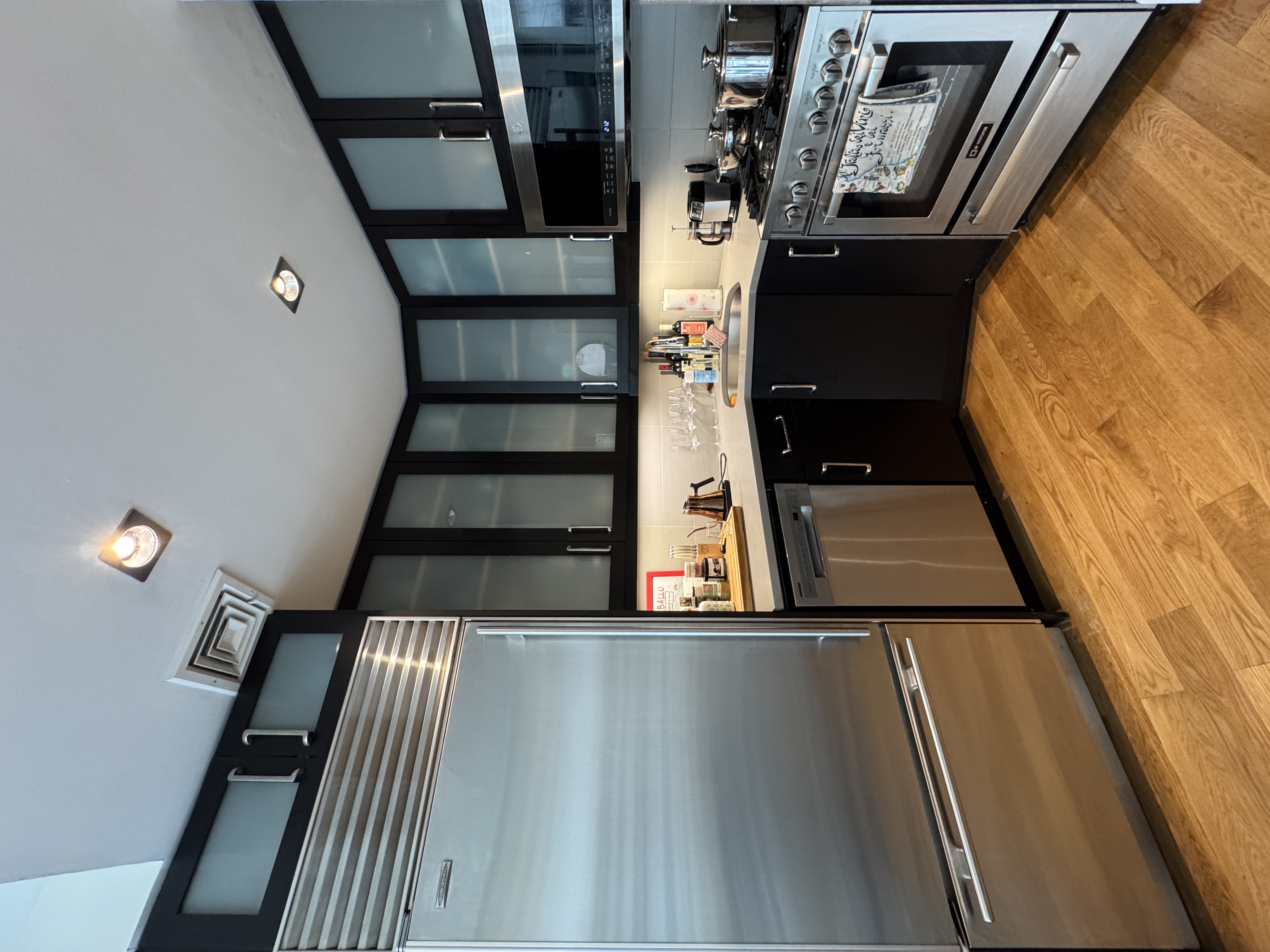 343 West 16th Street, Unit 3F Manhattan, NY 10011 - Photo 5 of 10 a kitchen with stainless steel appliances granite countertop a sink and cabinets