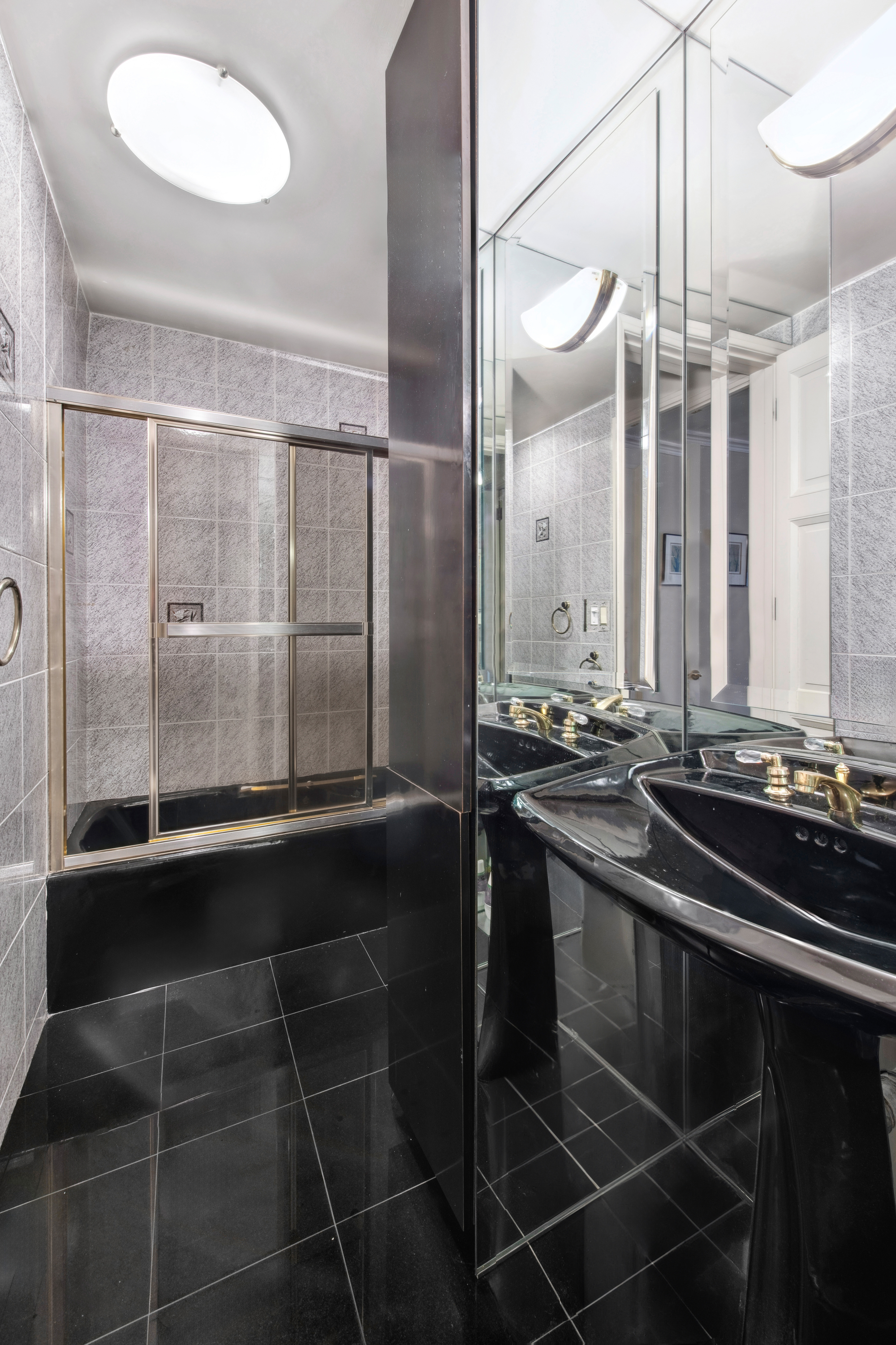 2 Sutton Place South, Unit 7F Manhattan, NY 10022 - Photo 12 of 18 a bathroom with a double vanity sink and mirror