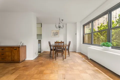 a dining room with furniture and window