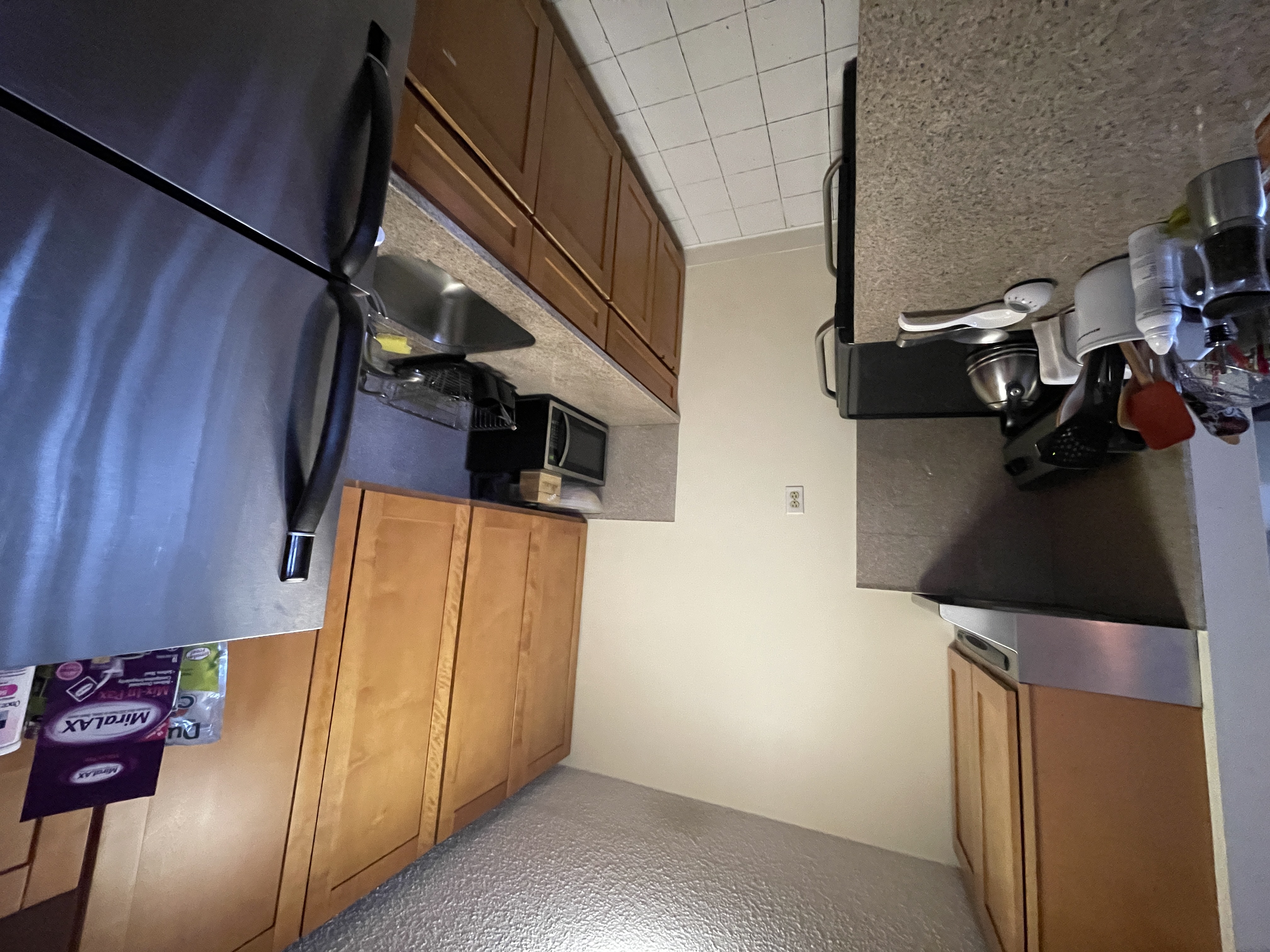 25-40 Shore Boulevard, Unit 5B Queens, NY 11102 - Photo 6 of 24 a kitchen with a refrigerator and a stove top oven