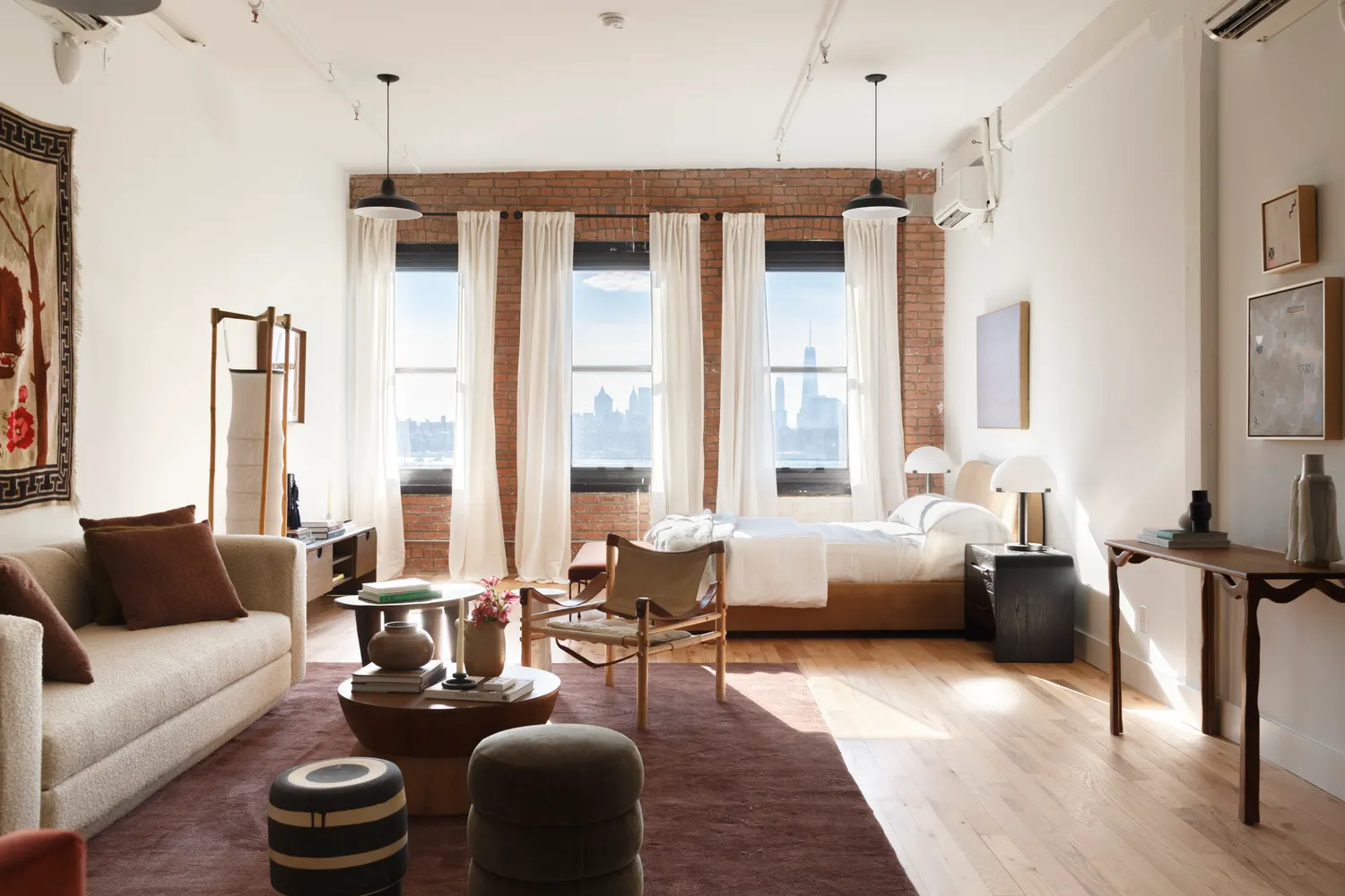 a living room with furniture and floor to ceiling windows