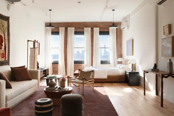 a living room with furniture and floor to ceiling windows