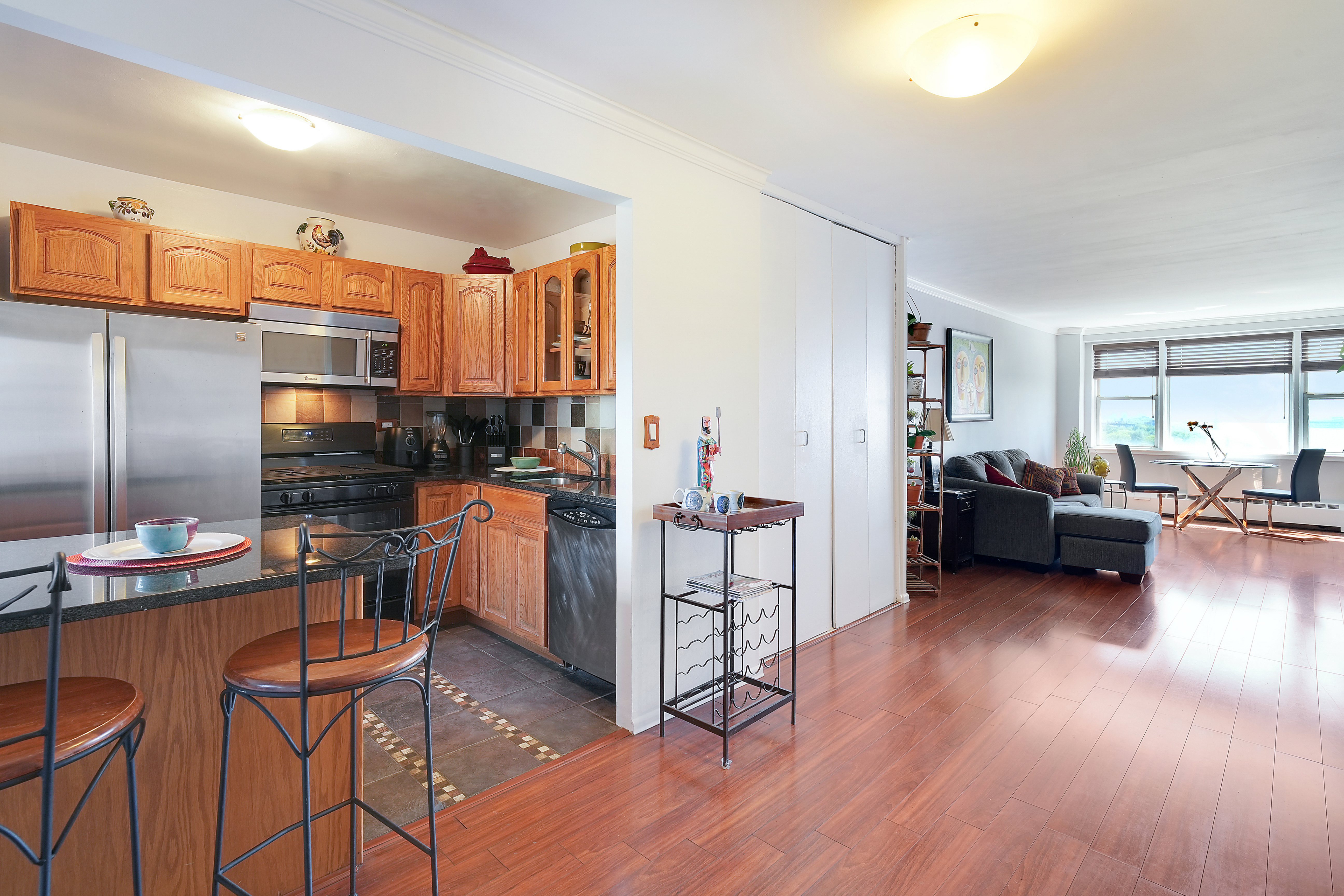 5700 Arlington Avenue, Unit 16T Bronx, NY 10471 - Photo 4 of 16 a living room with furniture and a wooden floor