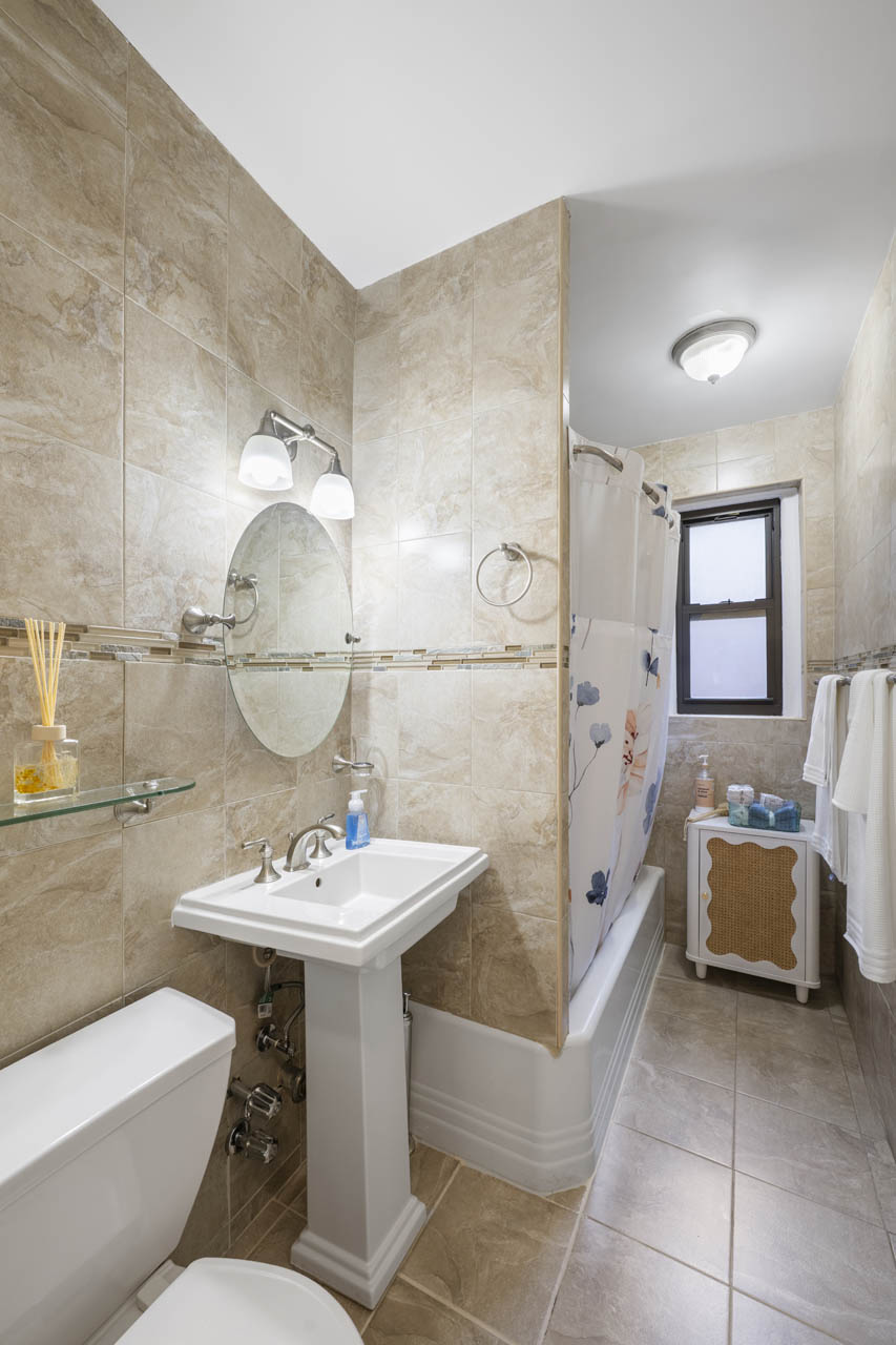 3215 Netherland Avenue, Unit 5C Bronx, NY 10463 - Photo 12 of 14 a bathroom with a sink toilet and shower