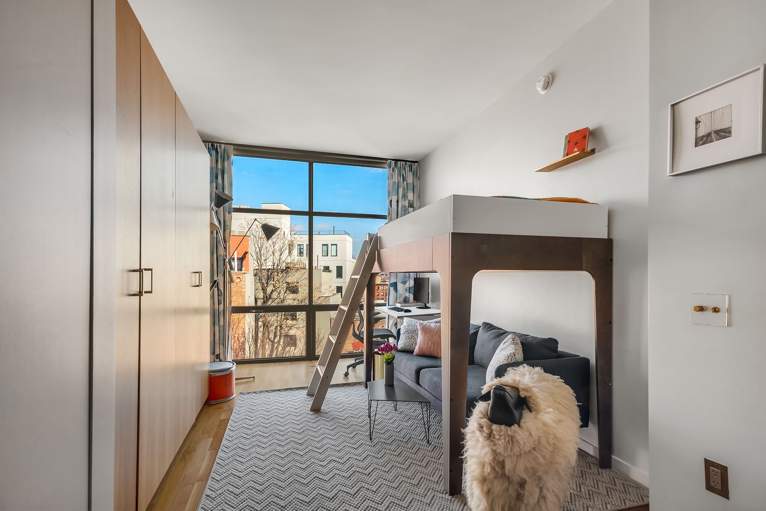280 Metropolitan Avenue, Unit 5D Brooklyn, NY 11211 - Photo 13 of 22 a hallway with a dining table a chandelier a mirror and a window
