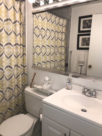 50 Lexington Avenue, Unit 15D Manhattan, NY 10010 - Photo 5 of 10 a bathroom with a sink a toilet and a mirror