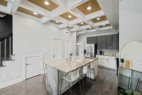 a kitchen with sink a center island and stainless steel appliances