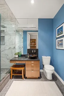 a bathroom with a sink a toilet and a mirror