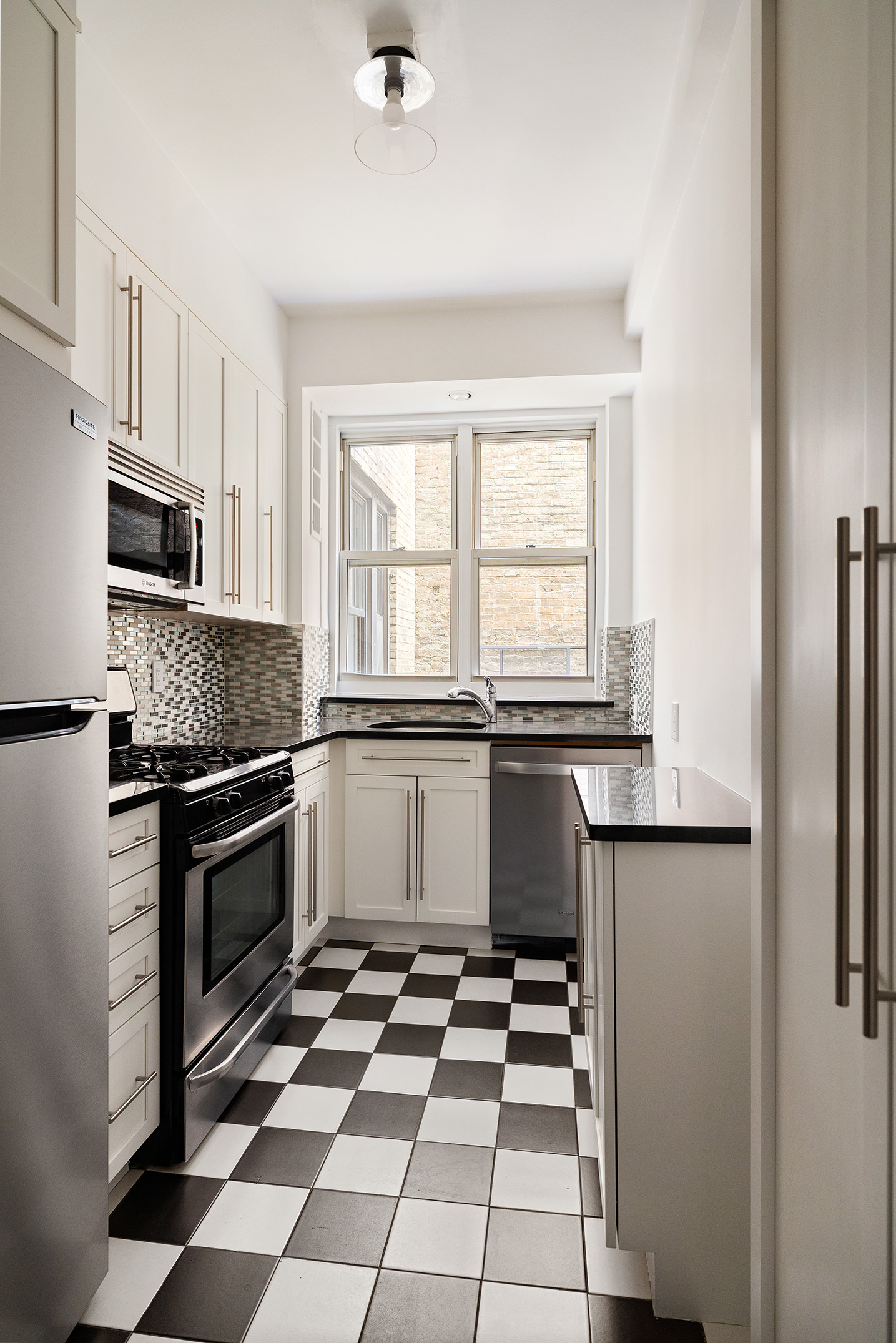 310 West End Avenue, Unit 2A Manhattan, NY 10023 - Photo 14 of 19 a kitchen with a sink a stove and cabinets