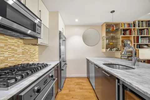 a kitchen with stainless steel appliances granite countertop a stove and a sink