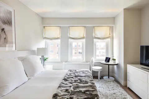 a spacious bedroom with a bed and a window