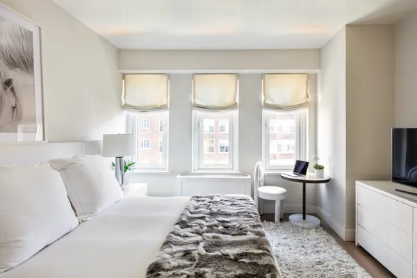 a spacious bedroom with a bed and a window