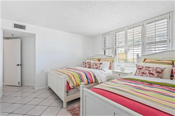 a bedroom with two beds and a window