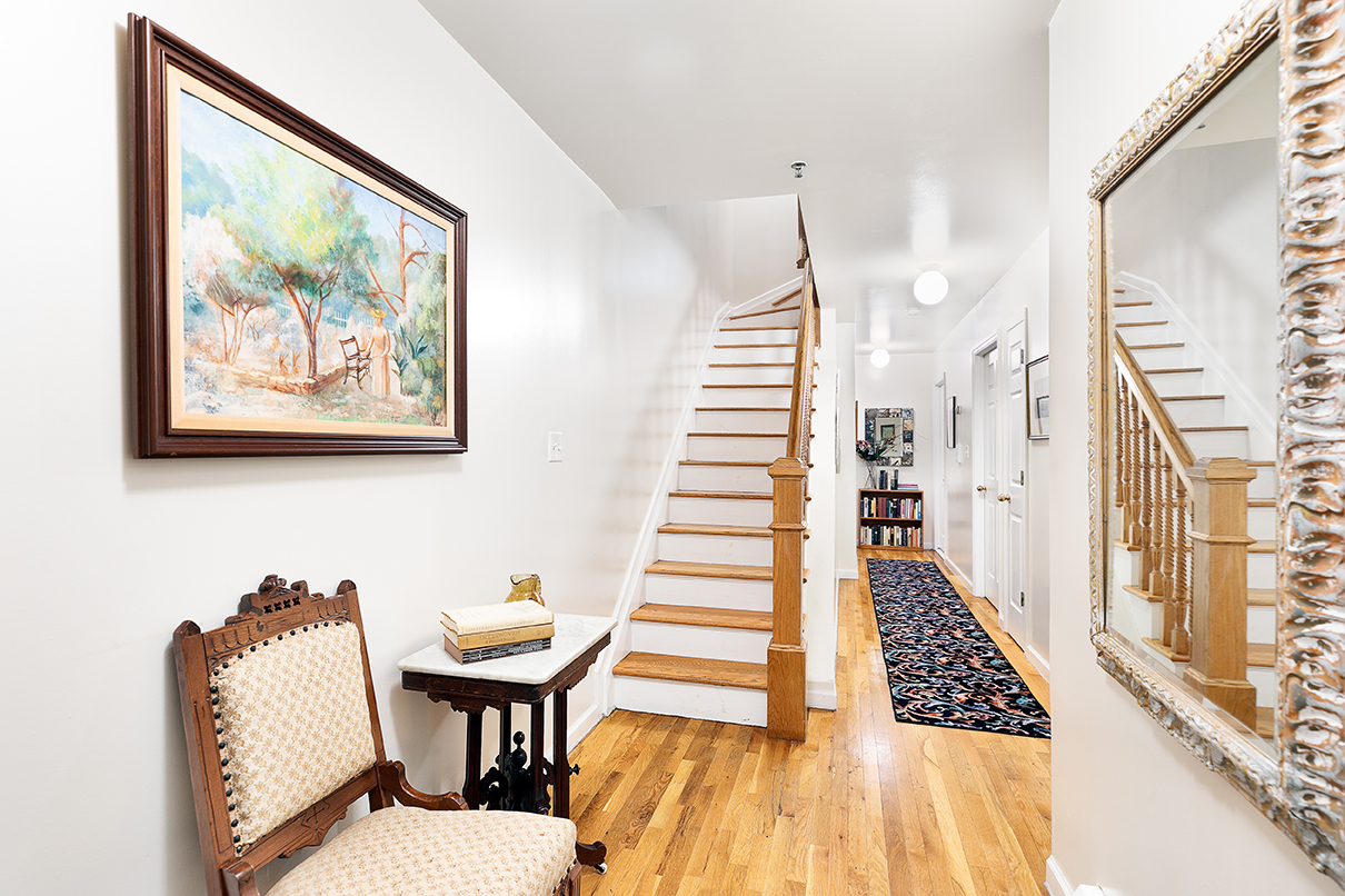 530 West 148th Street Manhattan, NY 10031 - Photo 3 of 14 a view of a hallway with furniture and wooden floor