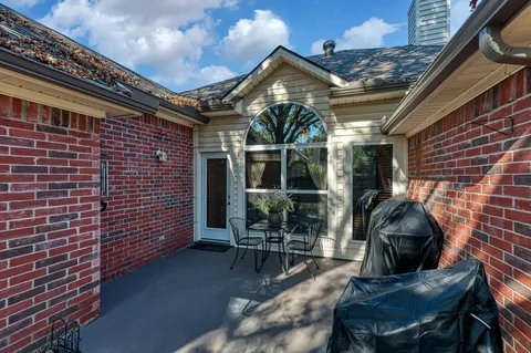 a roof deck with table and chairs and potted plants