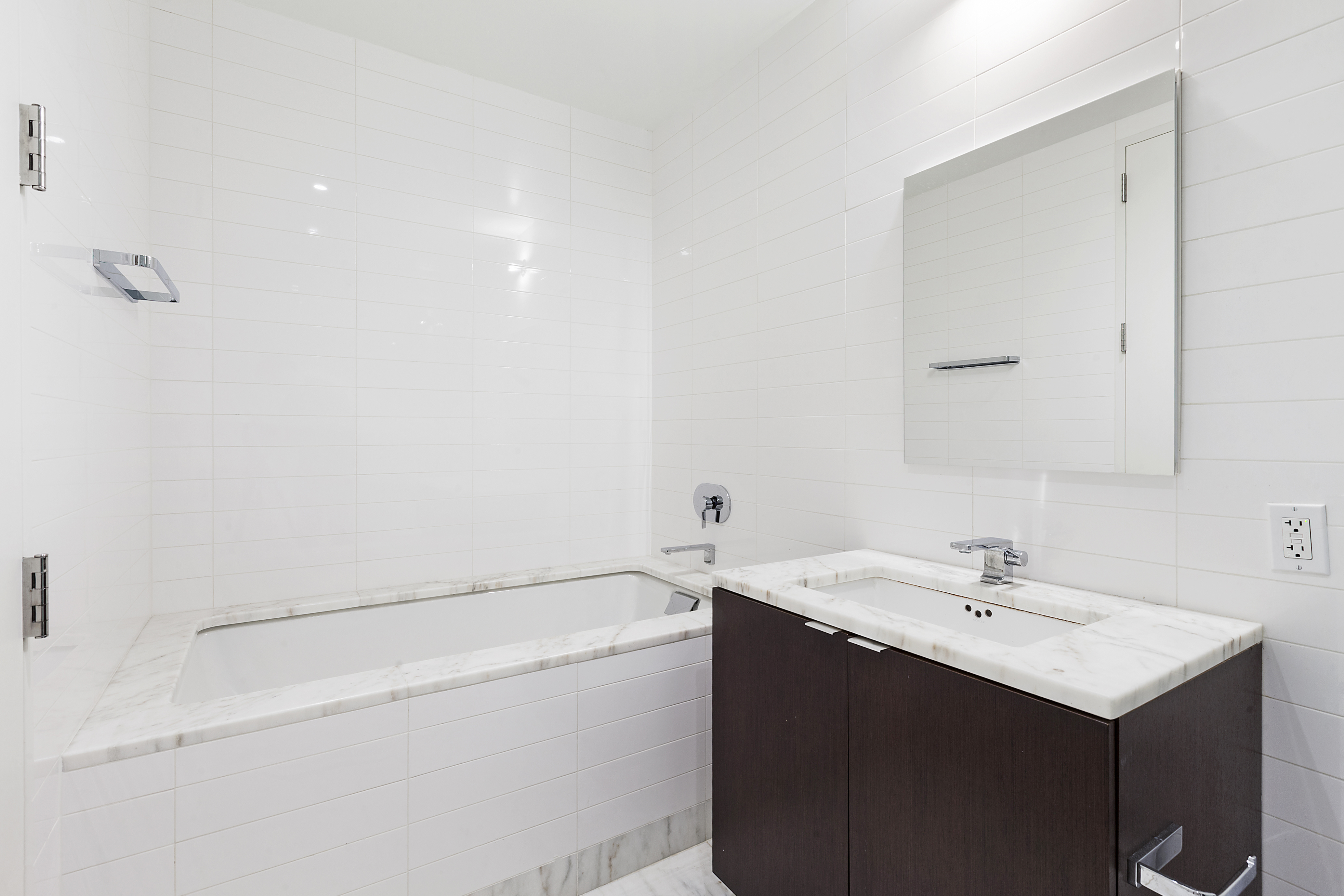 101 Warren Street, Unit 840 Manhattan, NY 10007 - Photo 6 of 16 a bathroom with a sink a vanity and a mirror