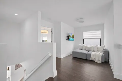 a bedroom with a bed and a stove with wooden floor