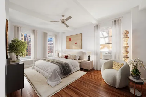 a bedroom with bed and wooden floor