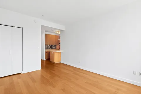 a view of a room with a empty space and wooden floor