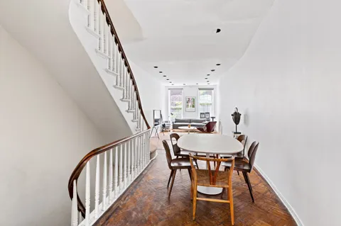a view of a dining room with furniture and wooden floor
