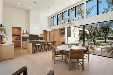 a view of a dining room with furniture and a floor to ceiling window