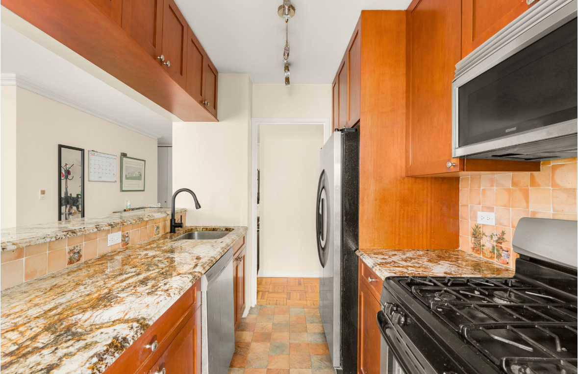 155 East 38th Street, Unit 5G Manhattan, NY 10016 - Photo 3 of 7 a kitchen with stainless steel appliances granite countertop a sink stove and refrigerator