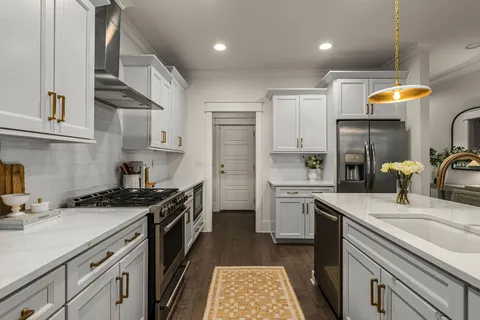 a kitchen with a sink stove and refrigerator