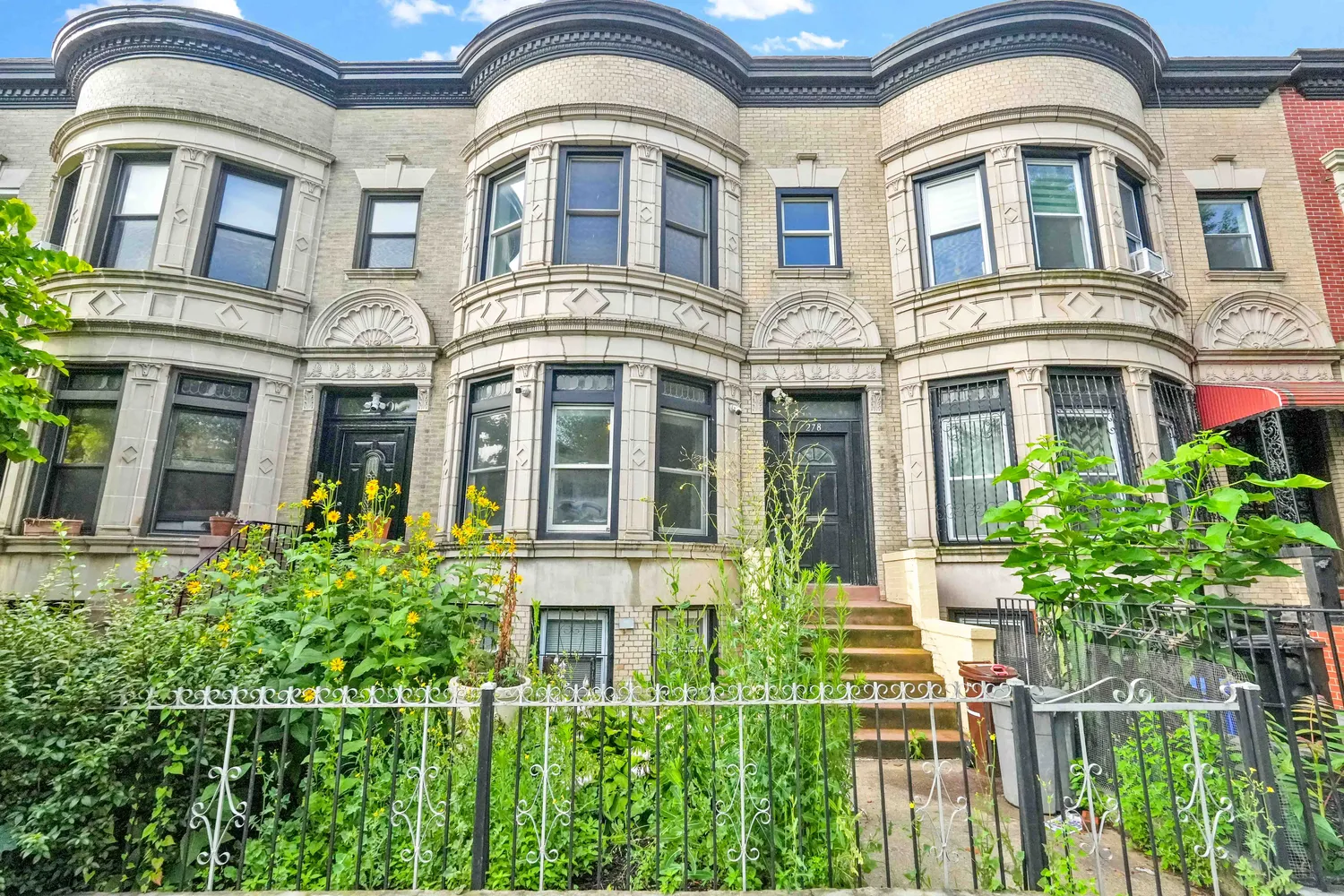 front view of a brick house with a large windows