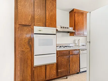 a kitchen with a stove and a refrigerator
