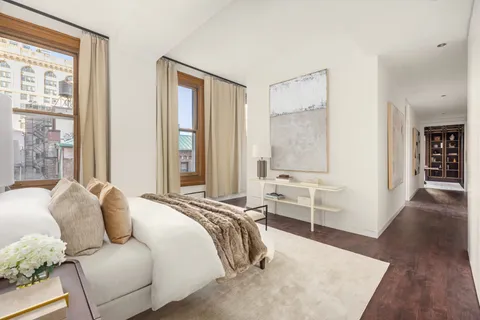 a bedroom with furniture and a window