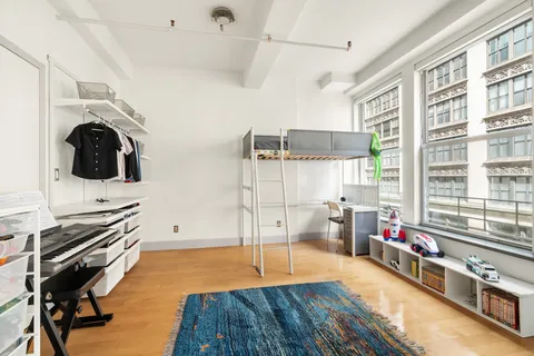 a bedroom with bed and cabinets