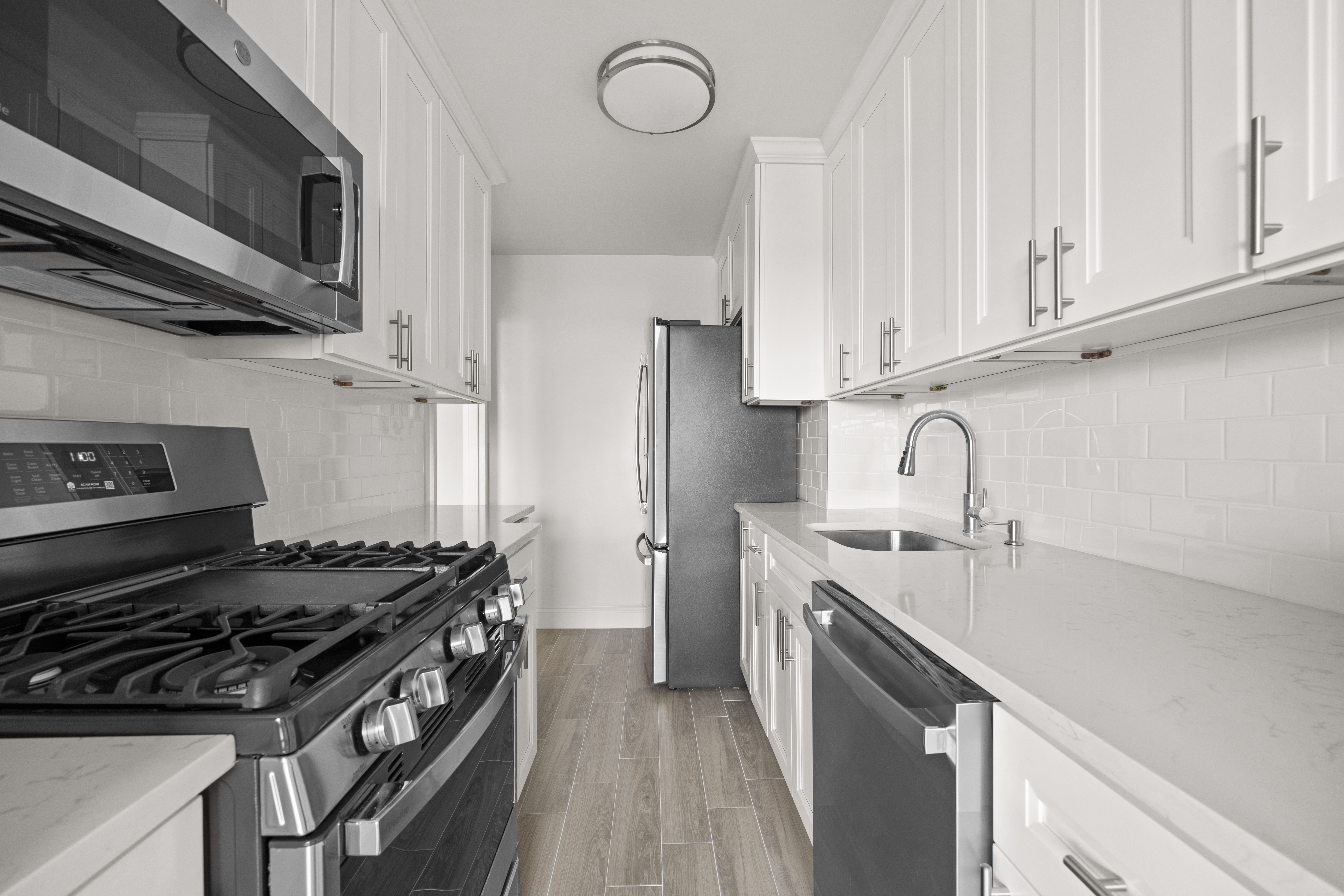 135 Ocean Parkway, Unit 9M Brooklyn, NY 11218 - Photo 7 of 18 a kitchen with stainless steel appliances granite countertop a stove and a sink