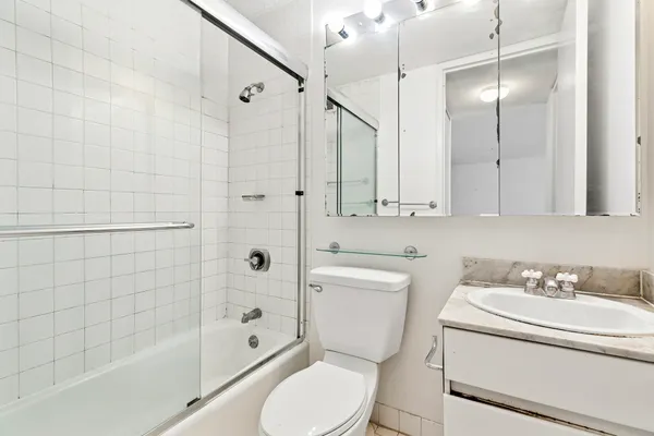 a bathroom with a sink toilet and shower