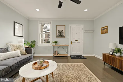 a living room with furniture and wooden floor