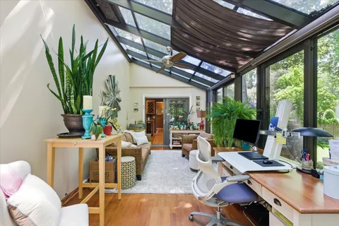 a work room with furniture and a large window