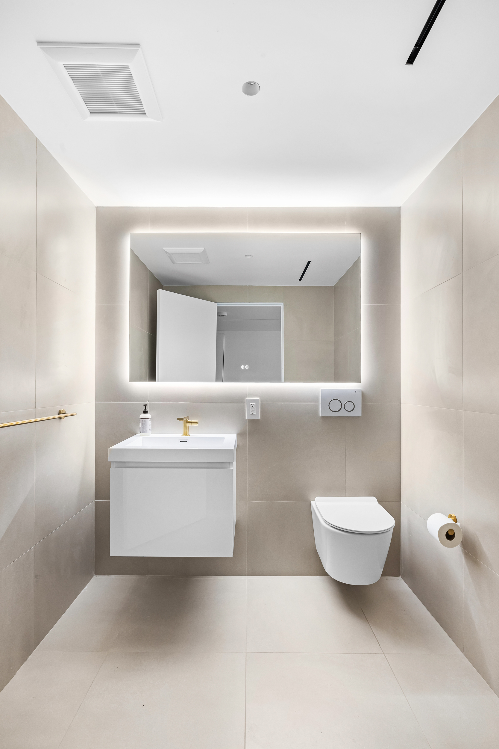 442 West 22nd Street Manhattan, NY 10011 - Photo 11 of 17 a bathroom with a sink a mirror and a toilet