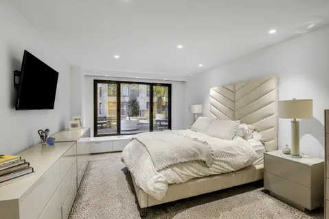 a bedroom with a bed and a flat screen tv