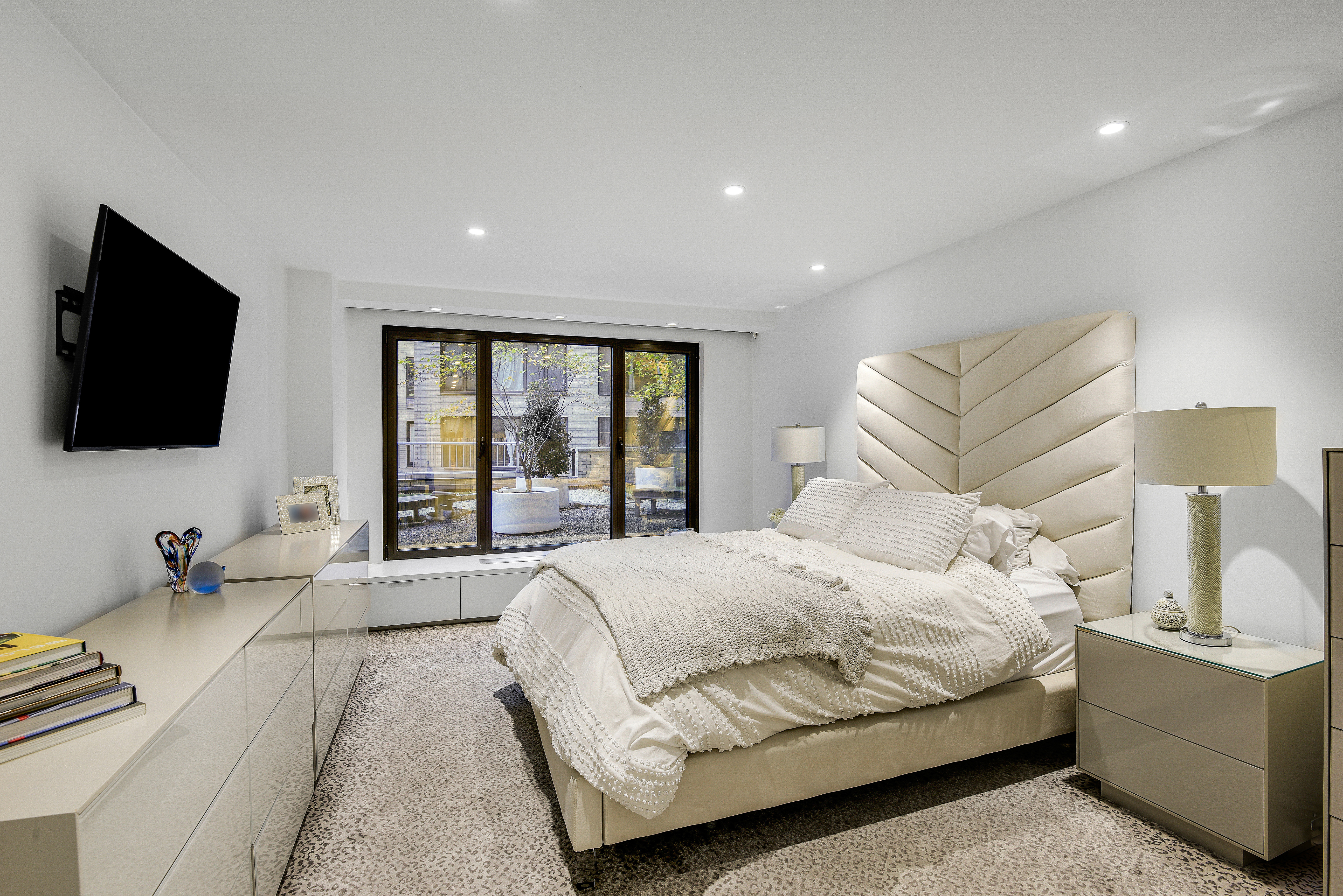 200 Central Park South, Unit 3Q Manhattan, NY 10019 - Photo 7 of 15 a bedroom with a bed and a flat screen tv