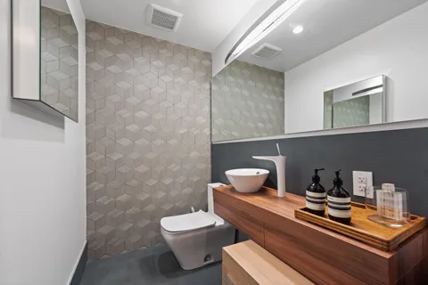 a room with a chair and potted plant on the wall