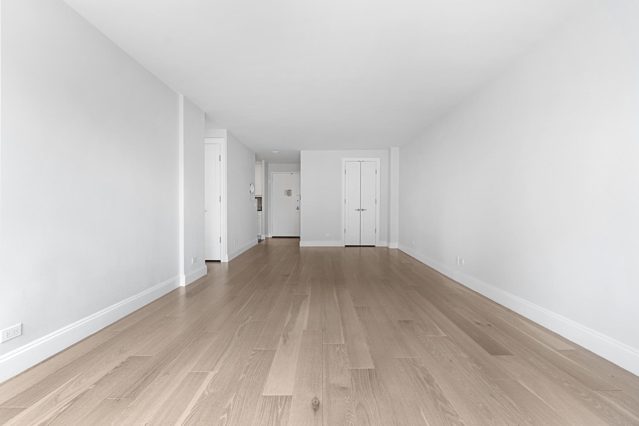 155 West 68th Street, Unit 1027 Manhattan, NY 10023 - Photo 6 of 8 a view of empty room with wooden floor