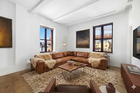 a living room with a couch and a window