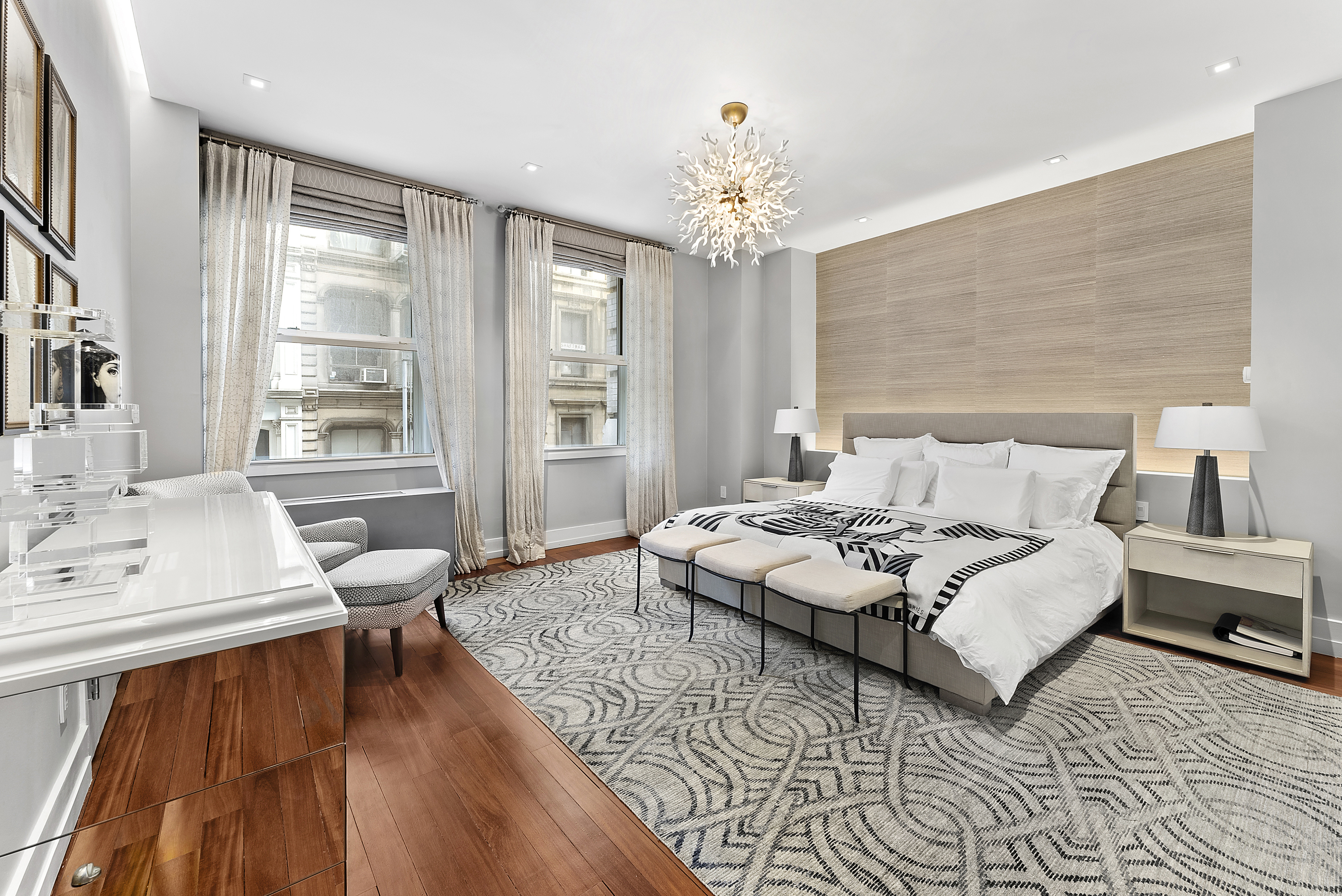 66 Leonard Street, Unit 2A Manhattan, NY 10013 - Photo 7 of 15 a spacious bedroom with a bed a chandelier and a large window