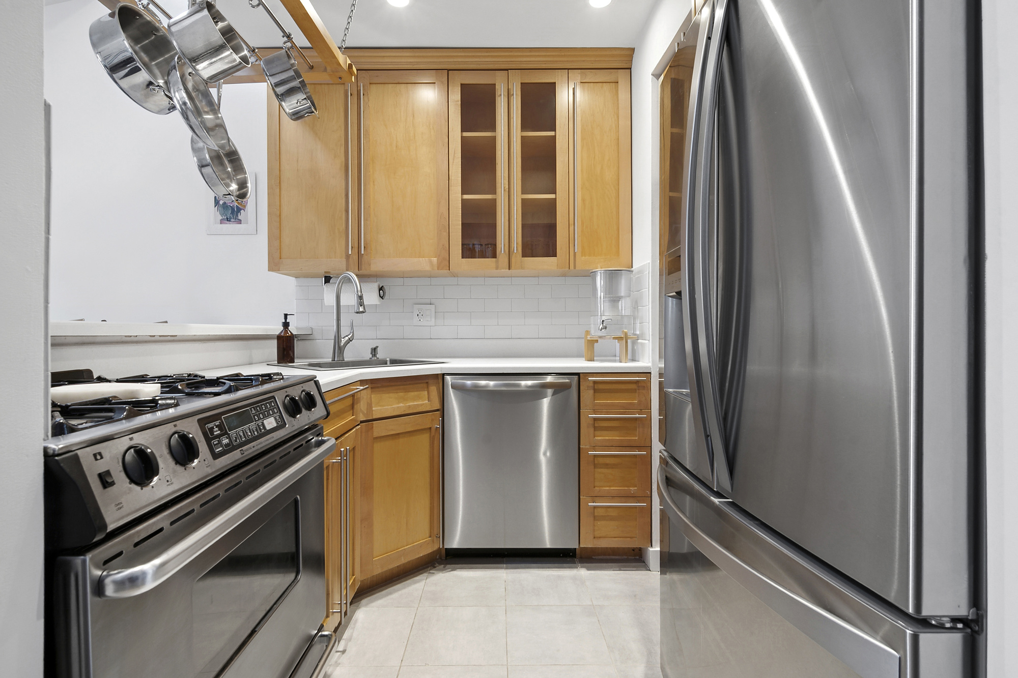 106 Battery Avenue, Unit 301 Brooklyn, NY 11209 - Photo 2 of 8 a kitchen with a stove and a refrigerator