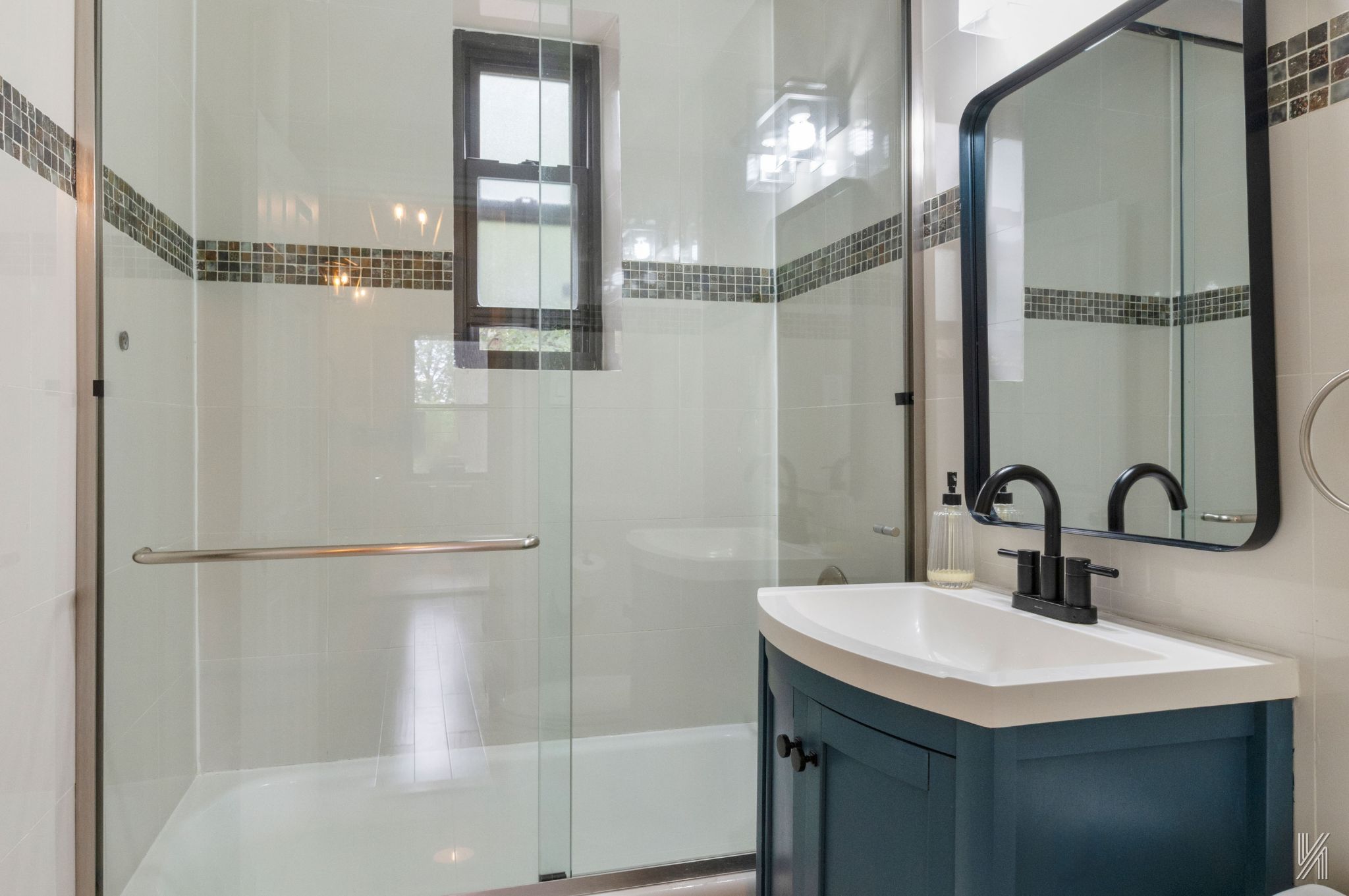 22-31 77th Street, Unit C2 Queens, NY 11370 - Photo 14 of 17 a bathroom with a sink and a mirror