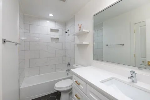 a bathroom with a sink toilet and shower