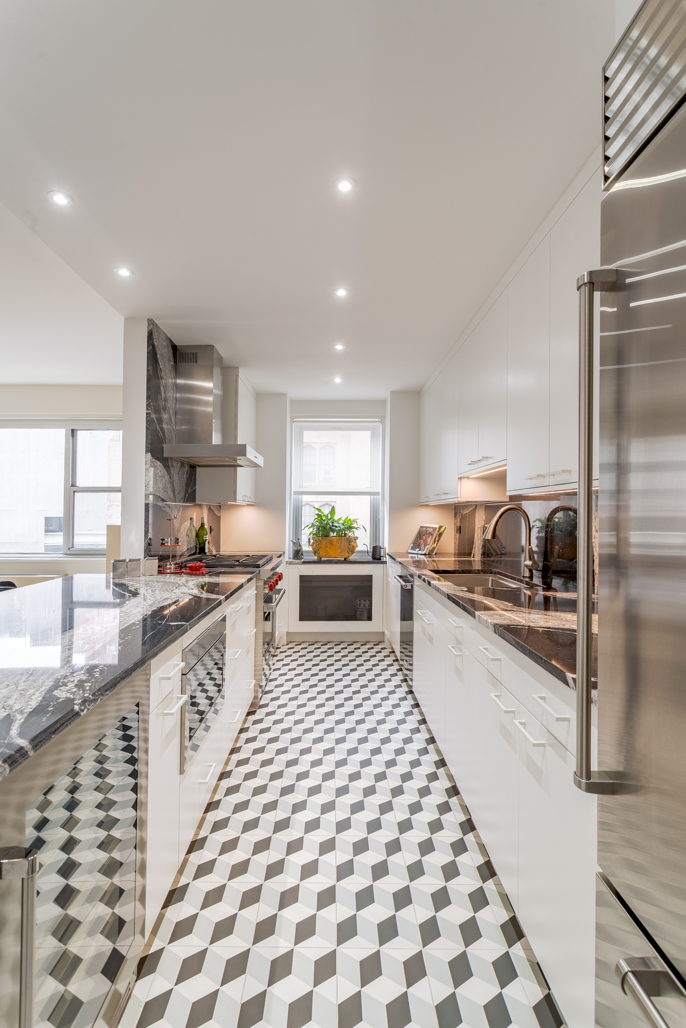 150 East 69th Street, Unit 5C Manhattan, NY 10021 - Photo 5 of 15 a large white kitchen with a sink and refrigerator