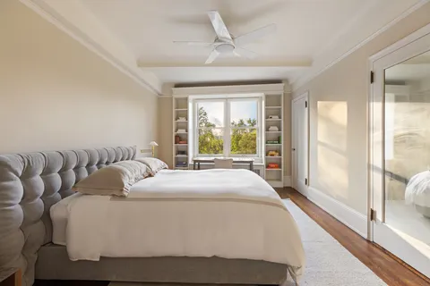 a bedroom with a large bed and a large window