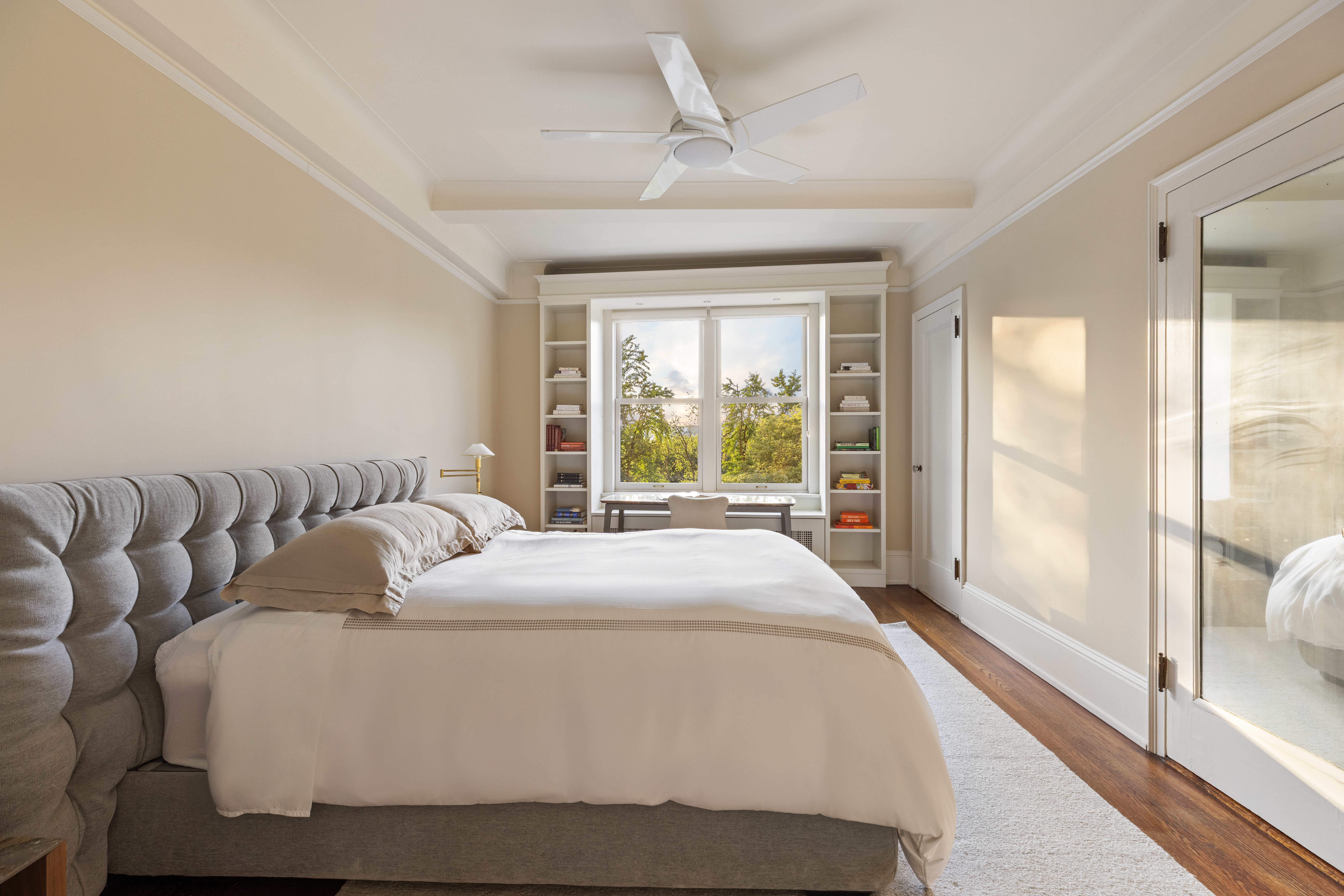 186 Riverside Drive, Unit 5F Manhattan, NY 10024 - Photo 8 of 15 a bedroom with a large bed and a large window